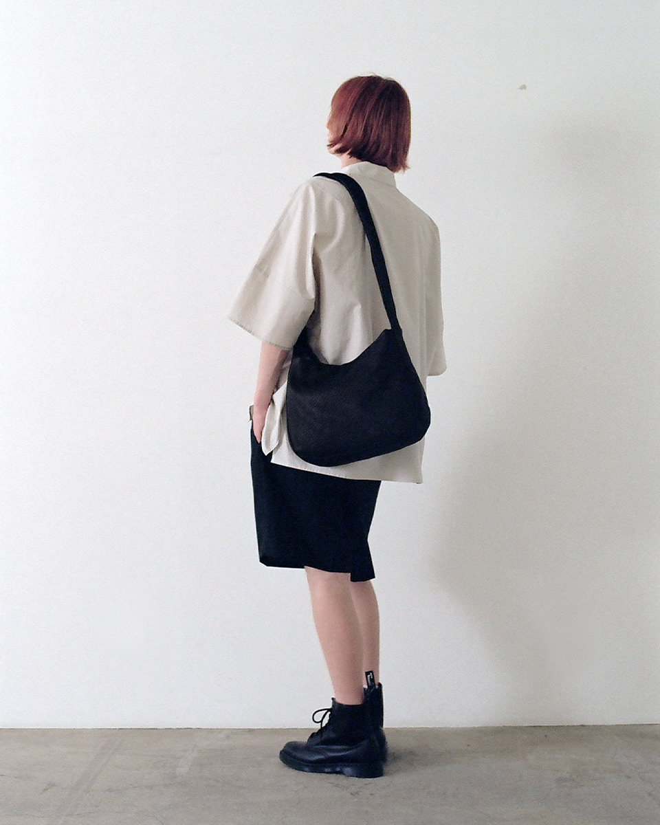 Black deer leather sash bag worn by model